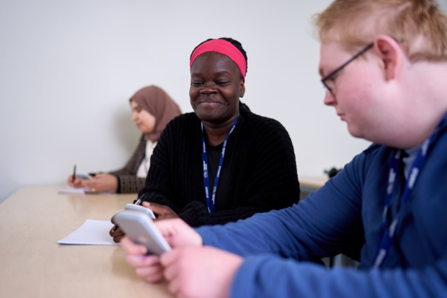Two students us a calculator GCSE Maths