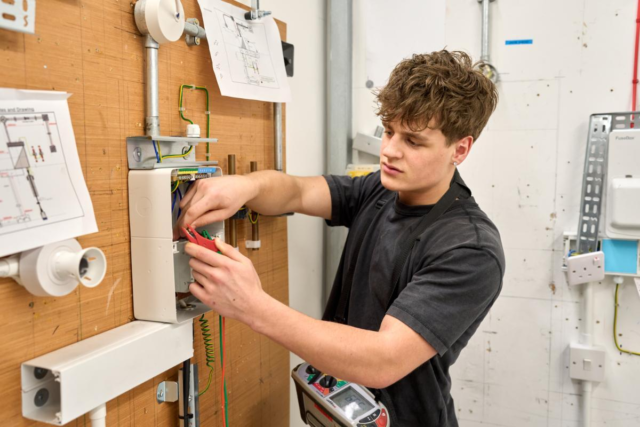 Student working in electrical workshop booth