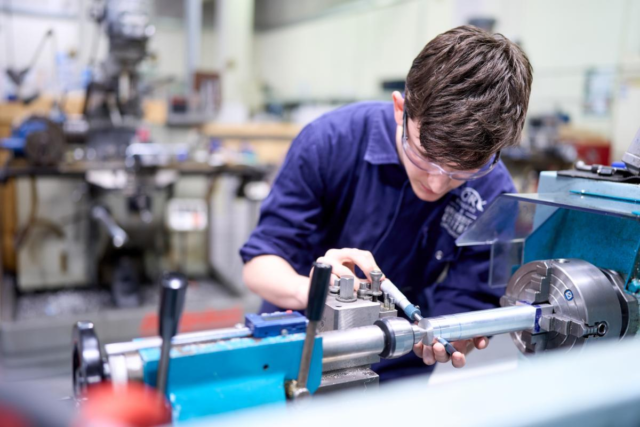 Student working on machinery in the workshop