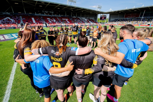 York City RLFC players are in a team huddle on the pitch
