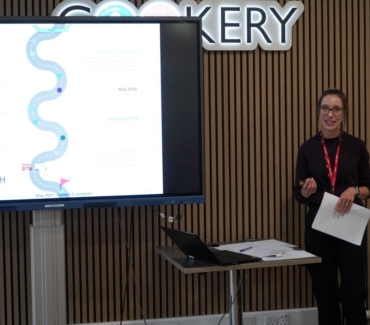 Katy Urakalo from Bettys Taylors addresses an audience in The Cookery restaurant at the side of a big screen