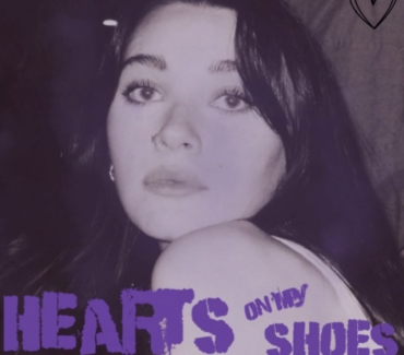 Daisy Summers Hearts on my Shoes single artwork shows her looking over the shoulder at the camera