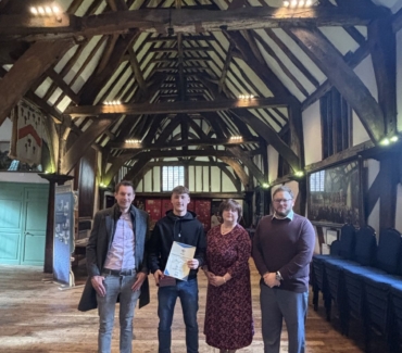 K Core representatives Greg Smith Elaine Hukins and James Selway stand in the Merchant Adventurers Hall with award winner Joe Jackson and his certificate