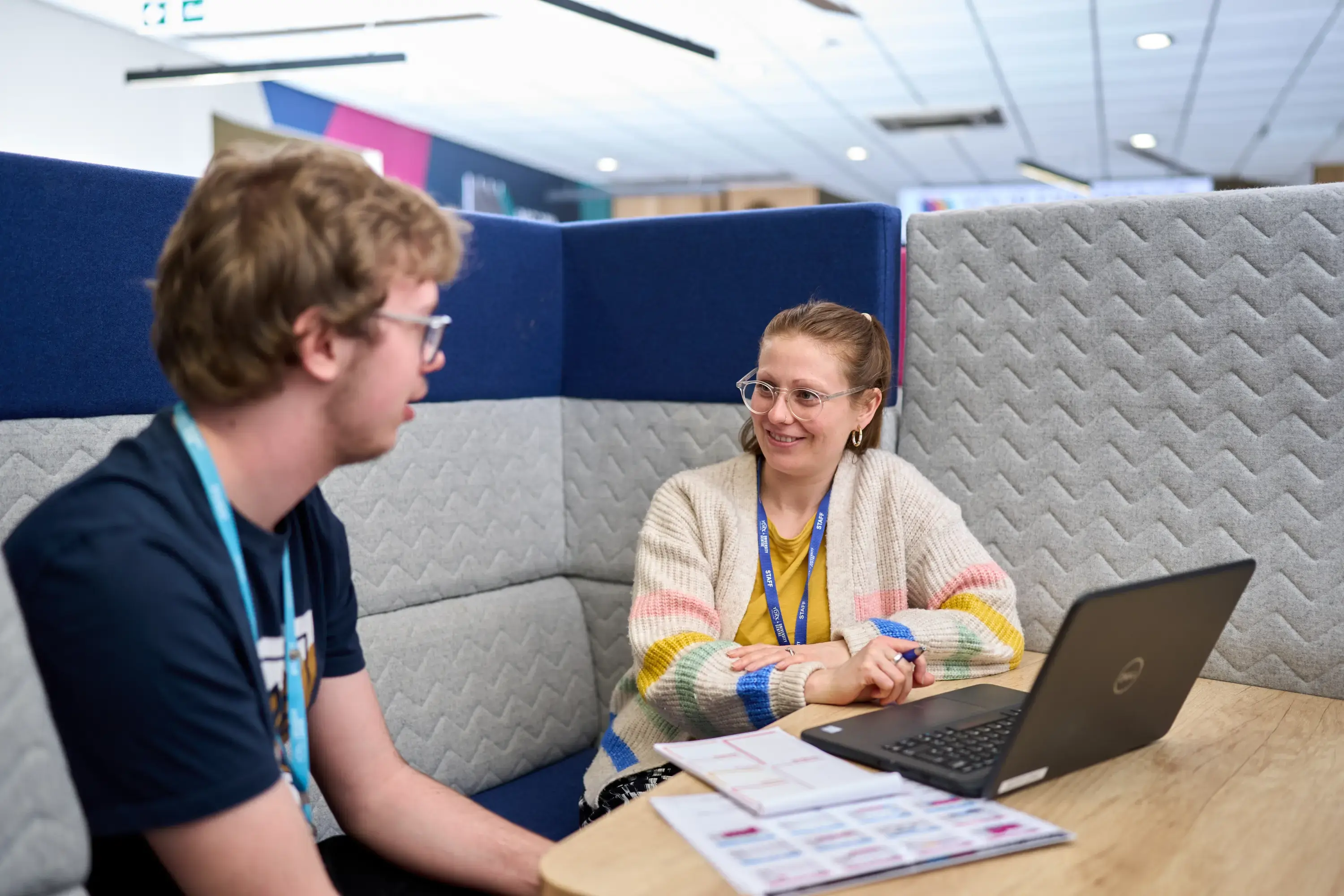 Student and staff member with laptop
