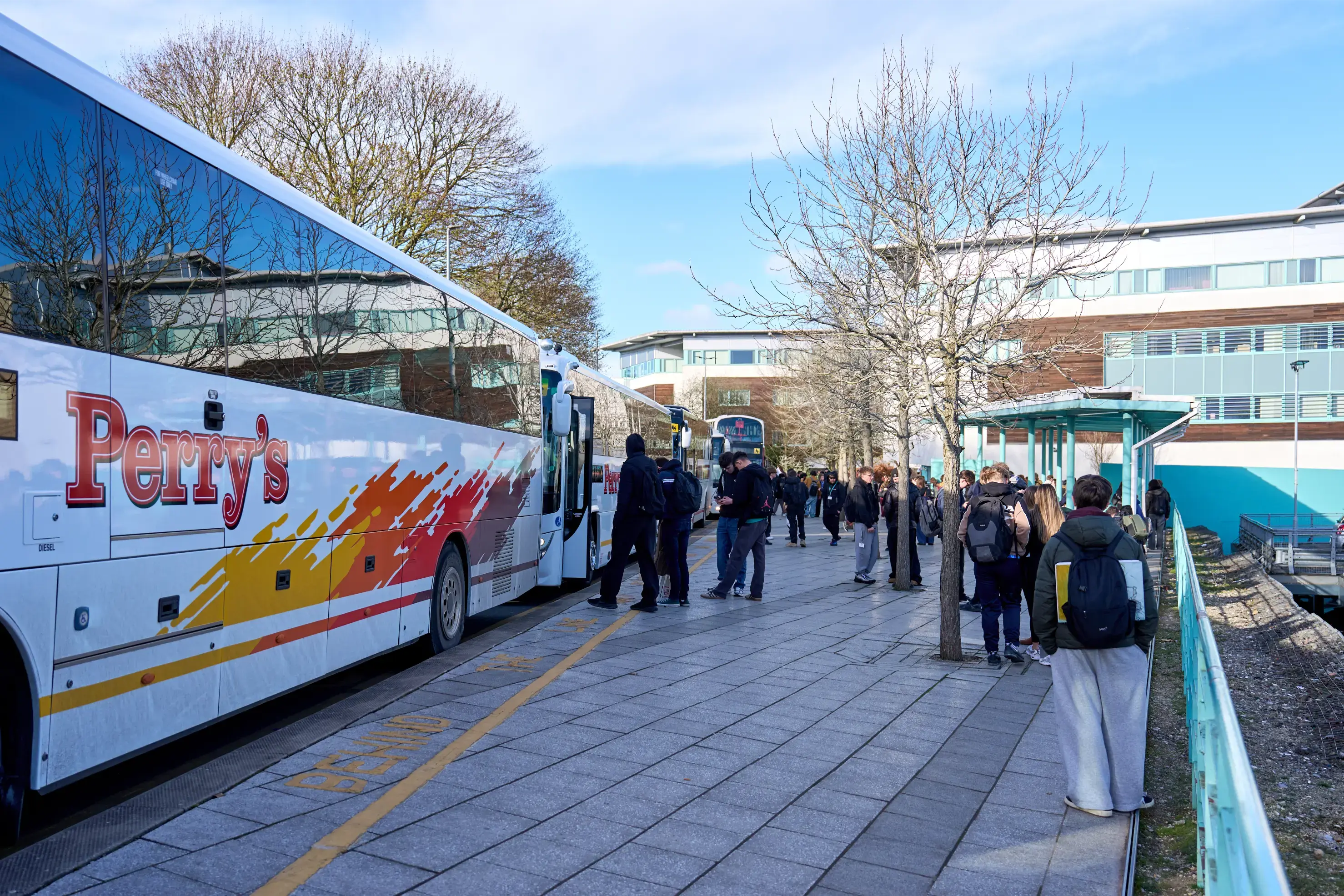 Students getting on college bus